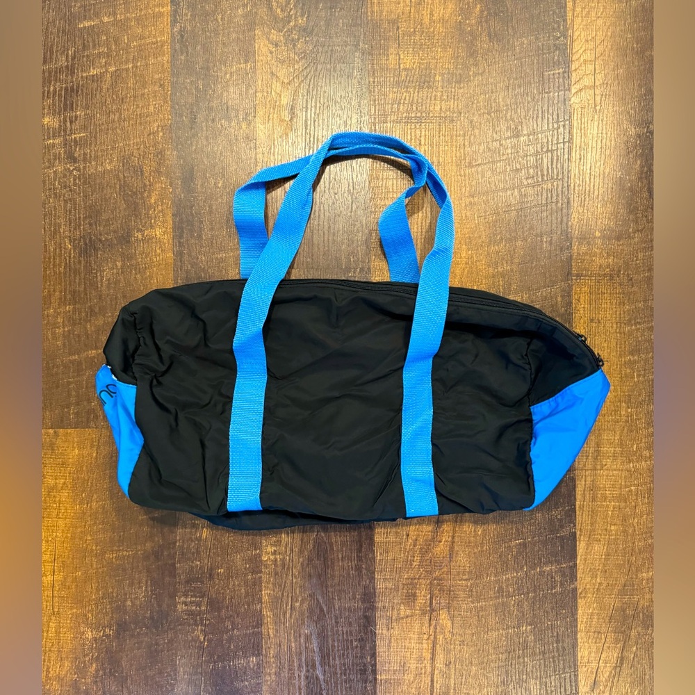 Bloomingdales black duffel bag with blue trim